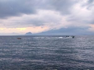 A fisherman and a lancha on Lake Atitlan